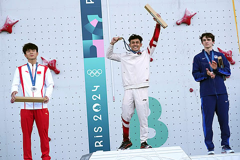Men's speed final: Gold medallist Veddriq Leonardo of Indonesia, center, silver medallist Wu Peng of China, left, and bronze medallist Sam Watson of the United States